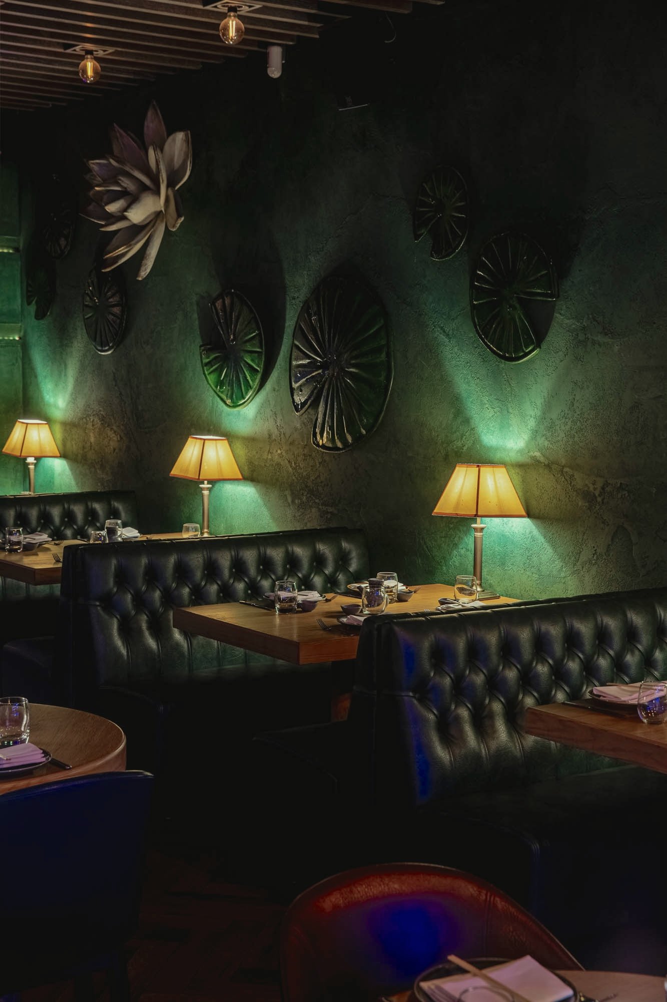 Ayllu restaurant interior with candlelit tables and green walls, Paddington London