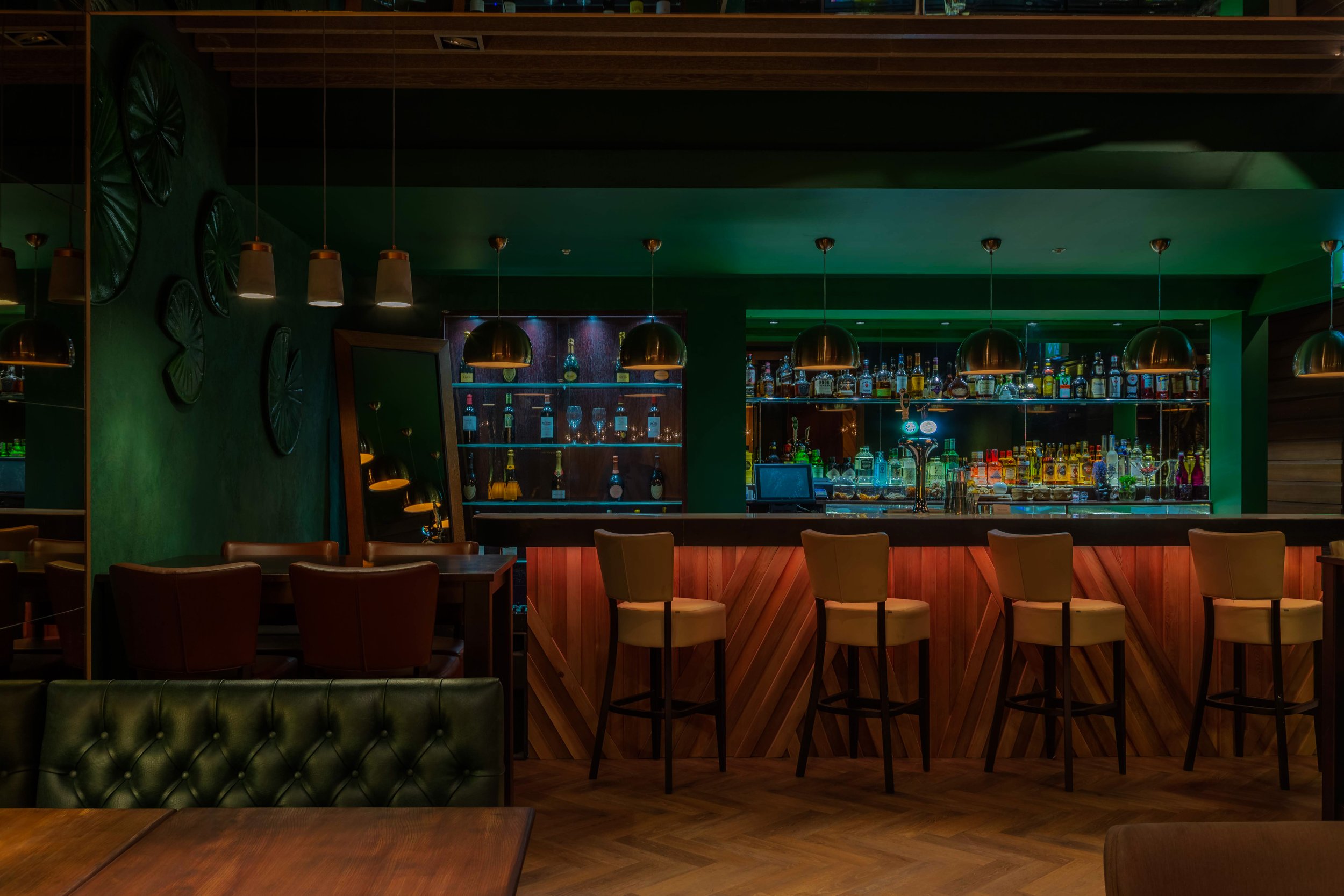 Ayllu restaurant interior with candlelit tables and green walls, Paddington London