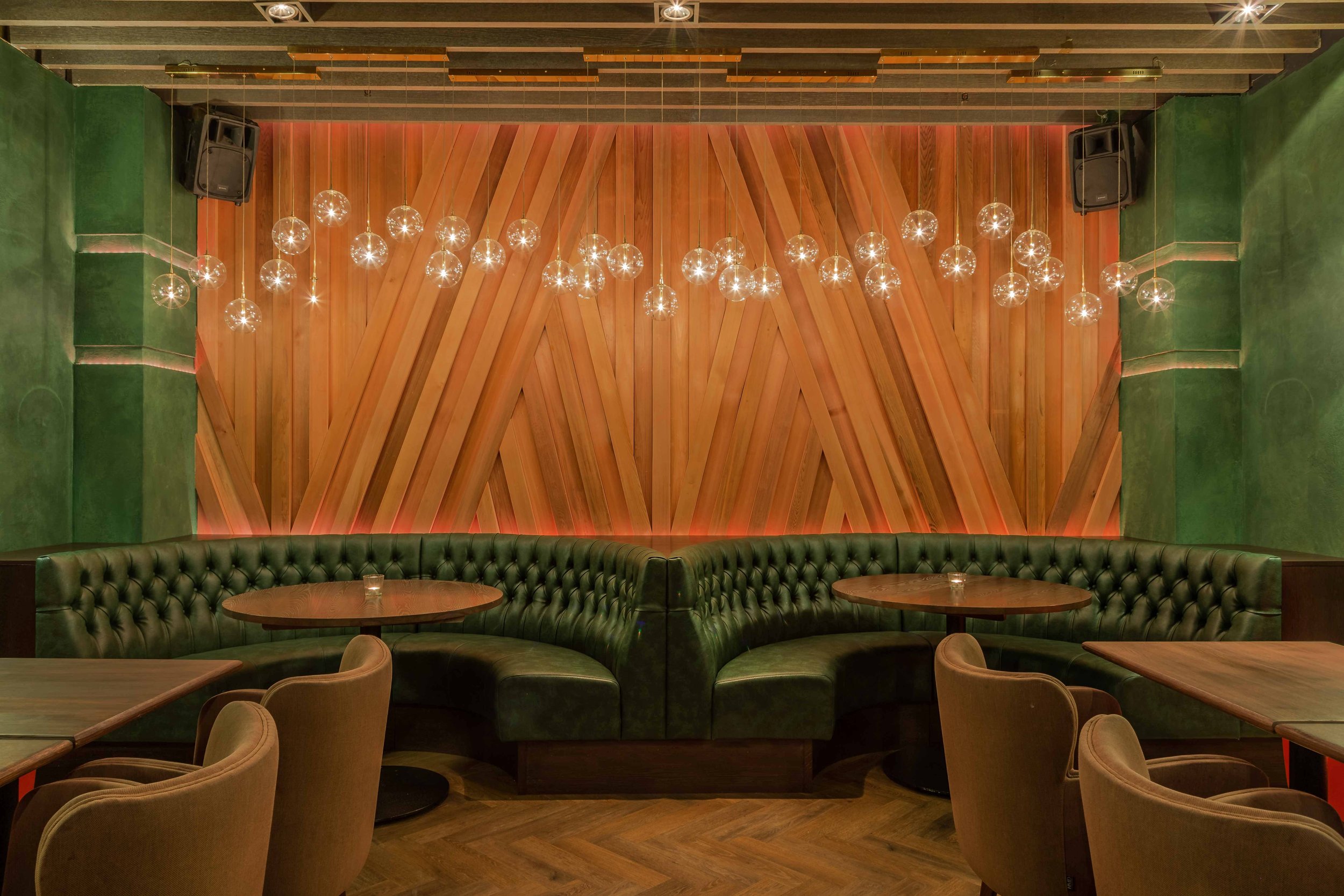 Dark-walled dining room with plush banquettes at Ayllu restaurant, Paddington